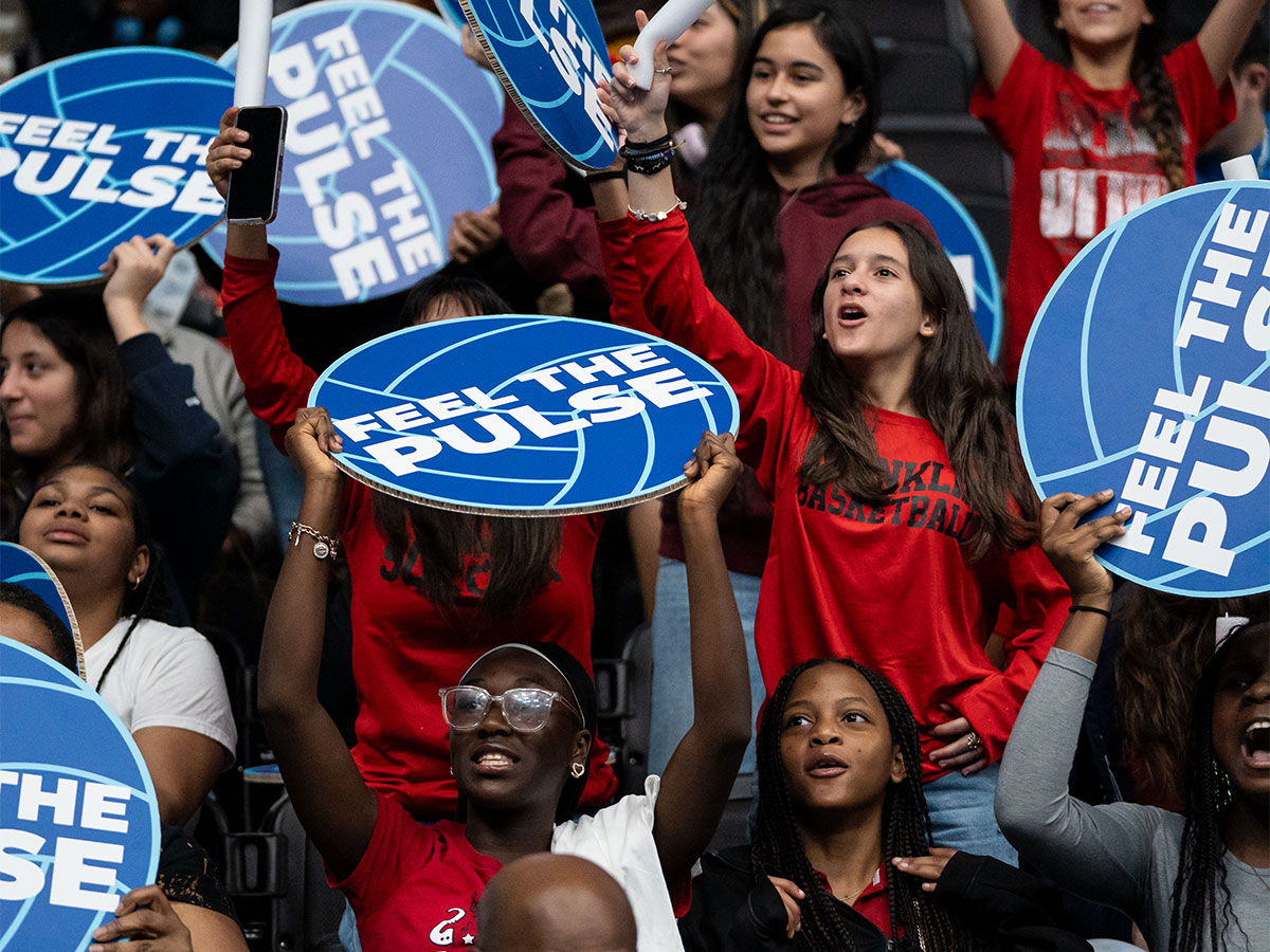 Youth cheering together at a professional sports game